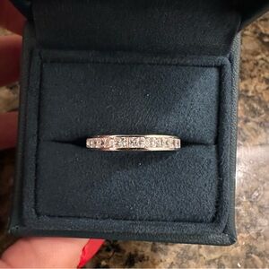 Princess cut channel set cubic zirconia diamond band ring.